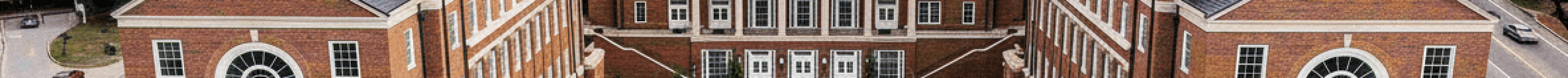 Aerial view of a university campus courtyard surrounded by academic buildings, representing Title IX investigation and compliance in higher education.